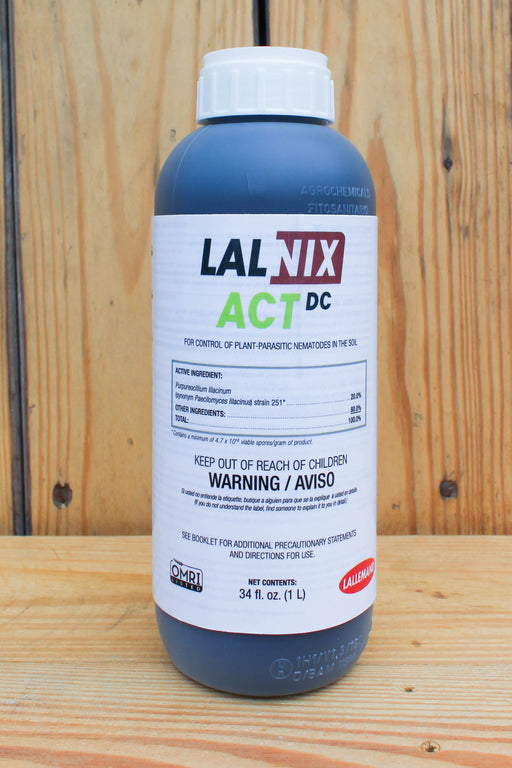 A white and black bottle of LALNIX ACT DC on a wood background.