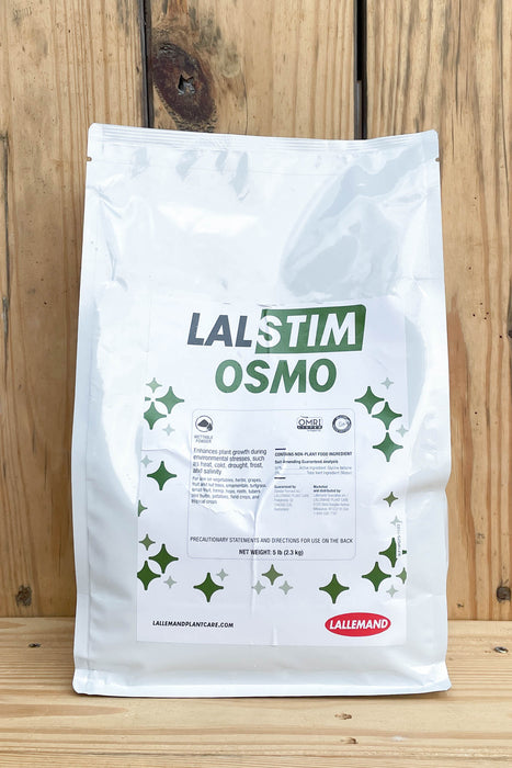 A white stand-up pouch of Lalstim Osmo, displayed against a rustic wooden plank background.