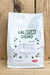 A white stand-up pouch of Lalstim Osmo, displayed against a rustic wooden plank background.