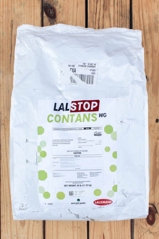 A 25 lb bag of LalStop Contans WG, displayed flat on a rustic wooden plank surface. The packaging is white with a prominent white label featuring green and red text and accents.
