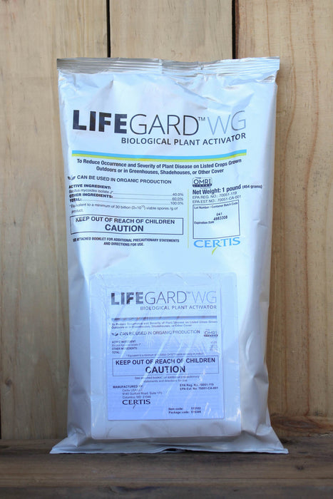 A silver bag of Lifeguard WG Biological Plant Activator standing upright against a light wood plank background.
