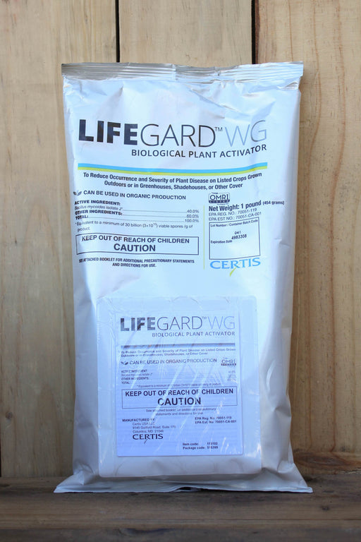 A silver bag of Lifeguard WG Biological Plant Activator standing upright against a light wood plank background.