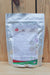 A stand-up pouch of MilAgro Keylamax Iron Organic 4-0-0 Soluble Powder Fertilizer, shown against a rustic wooden plank background.