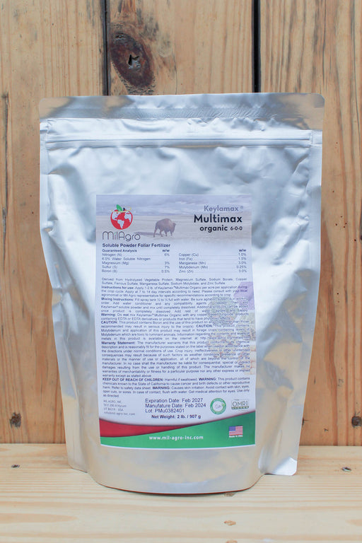 A silver stand-up pouch of MilAgro Keylamax Multimax, displayed against a rustic wooden plank background.