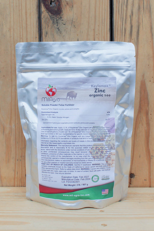 A silver stand-up pouch of MilAgro Keylamax Zinc Organic 5-0-0 Soluble Powder Fertilizer, displayed against a rustic wooden plank background.