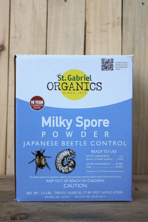 A box of St. Gabriel Organics Milky Spore Powder for Japanese Beetle Control, displayed on a wooden surface.