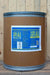 A large brown cardboard drum with a blue metal lid and a blue-and-white label reading 'Milky Spore Powder' photographed against a light wood plank wall and floor.
