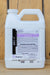 A white plastic jug of BioWorks Molt-X insecticide with a handle, standing on a light wood surface. The front label features black and purple text and sections for storage and disposal.