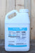 A large white plastic jug of Natural Wet , featuring a blue and white label, set against a rustic wooden plank background.