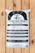 A 40 lb bag of Seven Spring Farm Supply Neversink Blend Natural Fertilizer, labeled 6-1-7, standing upright on a light brown wooden plank surface.