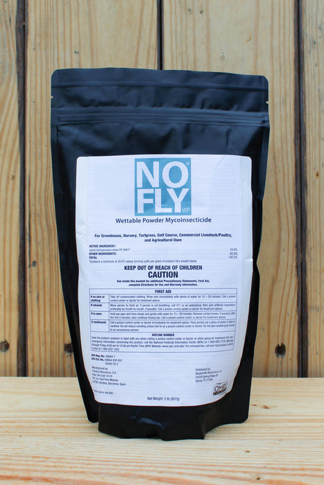 A black resealable pouch of NOFLY Wettable Powder Mycoinsecticide insecticide, featuring a large white label with blue and black text, set against a rustic wooden plank background.