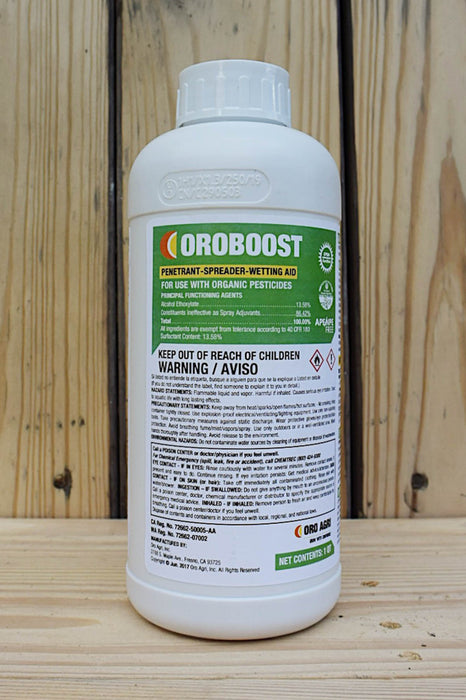 A white plastic bottle of OROBOOST Permanent Spreader-Wetting Aid with a green and white label, set against a rustic wooden plank background.