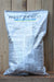 A large white plastic bag of PFR-97 20% WDG microbial insecticide, standing upright against a rustic wooden plank background.