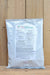 A 1 lb bag of PreBiotech prebiotic powder, standing upright against a light wood plank background.