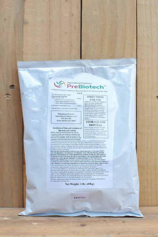 A 1 lb bag of PreBiotech prebiotic powder, standing upright against a light wood plank background.