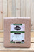 A large rectangular block of Redmond Natural Block premium mineral salt, featuring a white and green label, set against a rustic light wood plank background.