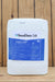 A large white plastic bucket of SaniDate 5.0, featuring a blue and white label, set against a rustic wooden plank background.