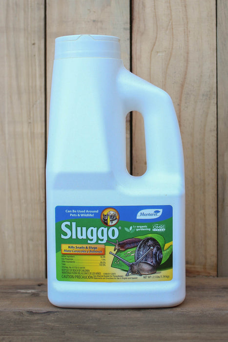 A white plastic bottle of Sluggo Slug  Control with a handle, set against a vertical wood plank background.