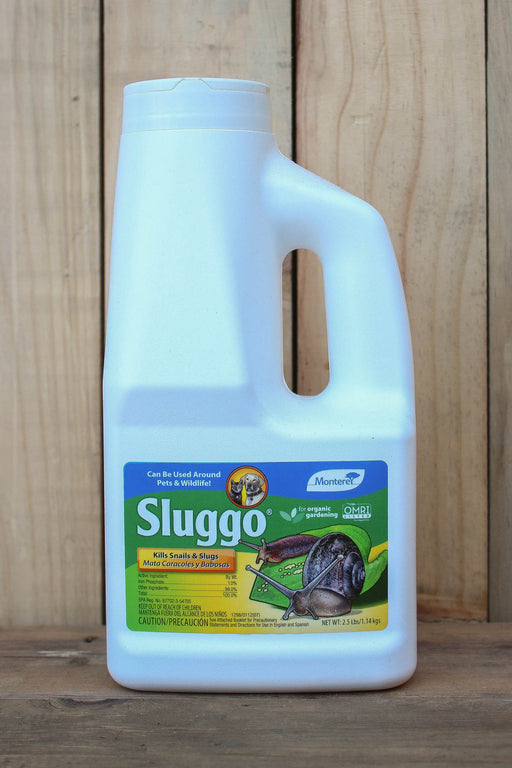 A white plastic bottle of Sluggo Slug  Control with a handle, set against a vertical wood plank background.