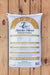 A 40 lb bag of Seven Springs Farm Supply Starter Blend Natural Fertilizer, labeled 9-2-2, standing upright on a rustic wooden plank surface.