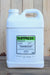 A large white plastic jug of Suppress Herbicide EC standing upright against a light wood plank background.