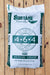 A 50 lb bag of Sustane Naturally 4-6-4 Medium Grade slow release nitrogen fertilizer, displayed on a light-colored wooden plank background.