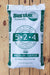 A 50 lb bag of Sustane 5-2-4 Medium Grade slow release nitrogen fertilizer, shown on a light-colored wooden plank background.