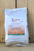 A white plastic bag of Tenet WP standing upright against a light wood plank background.