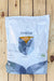 A 15 lb bag of AgBiome Theia, displayed flat on a light-colored wooden plank surface.