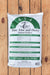 A 40 lbs bag of Seven Springs Farm Supply Tree, Vine and Berry Natural Fertilizer, displayed on a light brown wooden plank background.