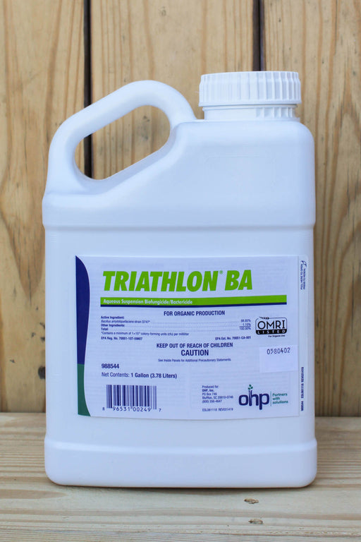 A white plastic jug of Triathlon BA, set against a light wood plank background.