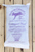 A white bag of Vermont Compost Company Compost Plus container and transplant booster mix, displayed flat against a light-colored wooden plank background.