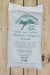 A 20-quart white bag of Vermont Compost Company Manure Compost, featuring green printed text and logo, photographed flat on a light wood plank background.