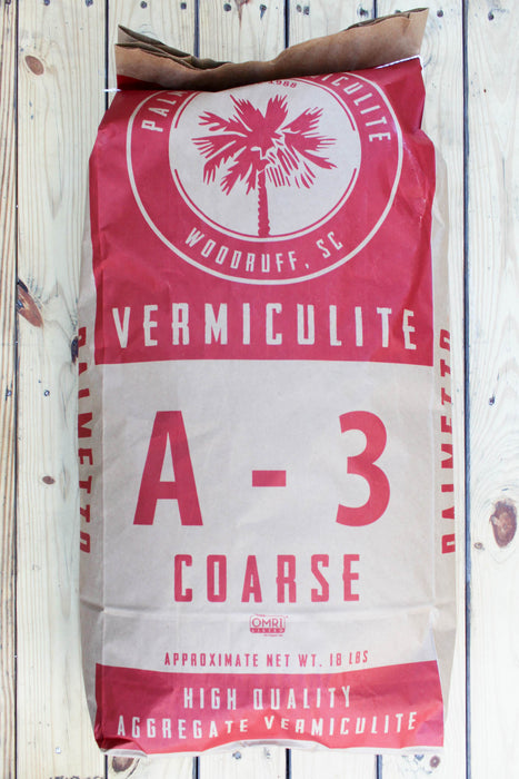 A large bag of Vermiculite A-3 Coarse high quality aggregate vermiculite, displayed on a rustic white wood plank background.