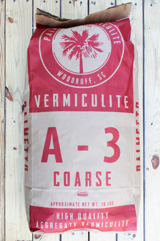A large bag of Vermiculite A-3 Coarse high quality aggregate vermiculite, displayed on a rustic white wood plank background.
