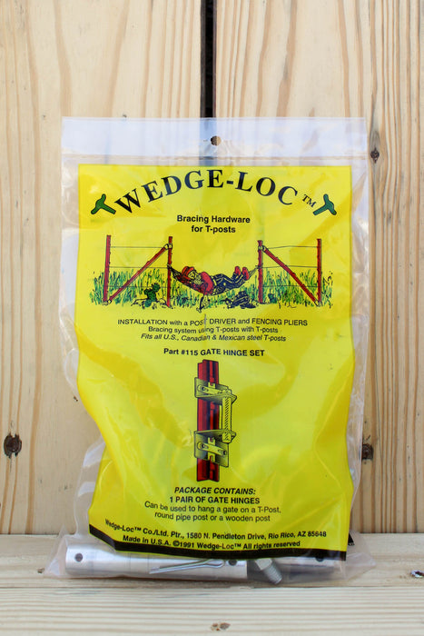 A package of Wedge-Loc gate hinge set hardware in a clear plastic bag with a bright yellow insert card, photographed against a light wood plank background.