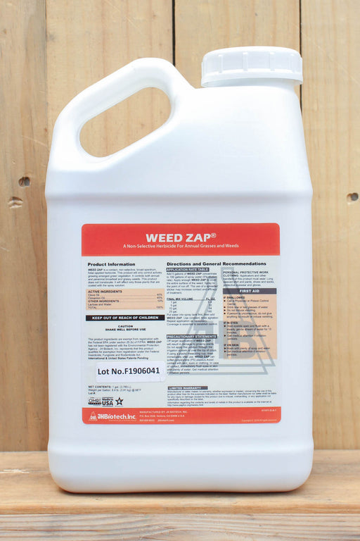 A white plastic jug of Weed Zap herbicide with a detailed product label, set against a rustic wooden plank background.