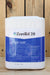 A large white plastic jug of ZeroTol 2.0 with a blue and white label, set against a rustic wooden plank background.